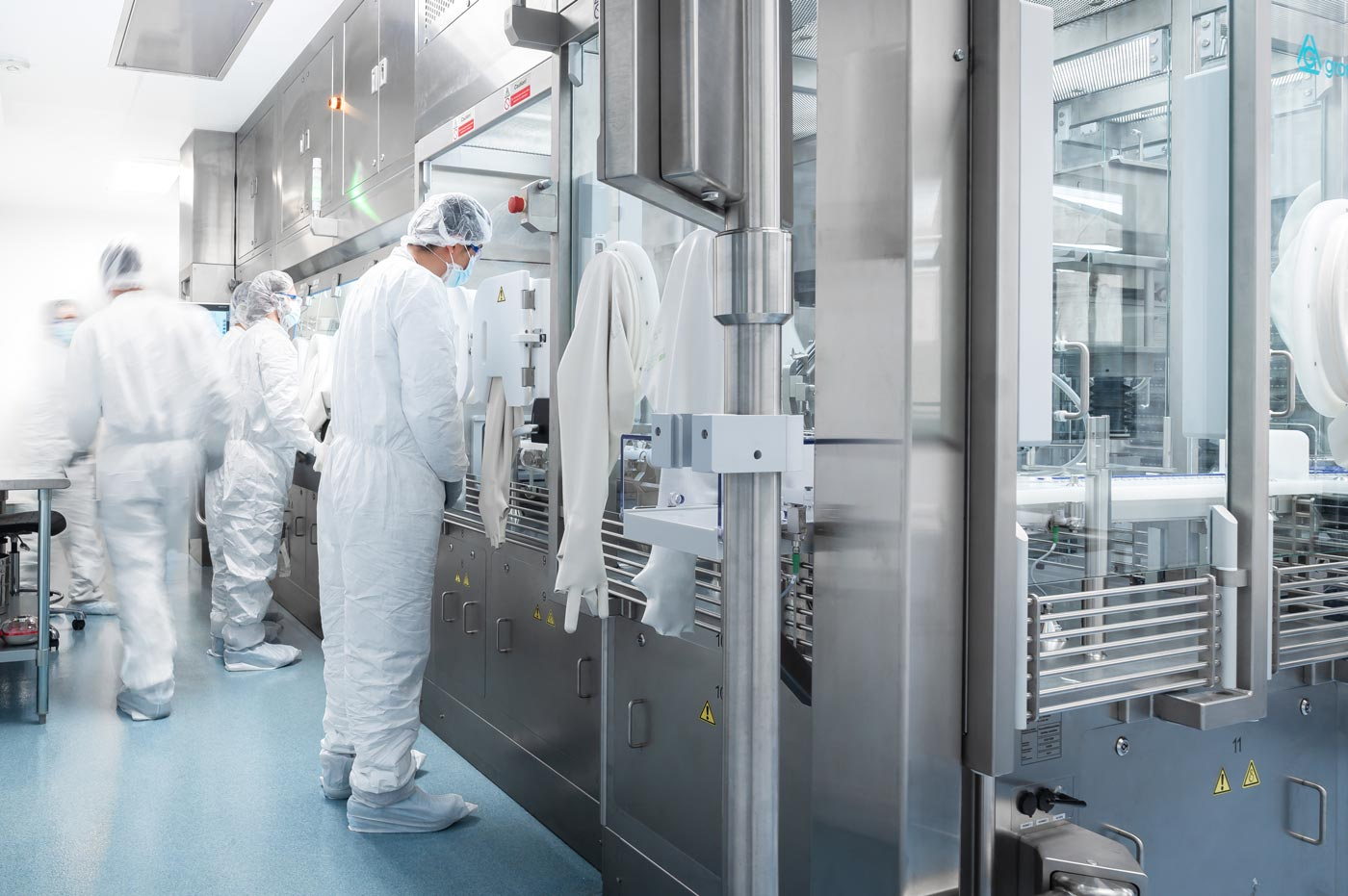 Gowned operators at an aseptic filling line inside the BPI Labs manufacturing facility
